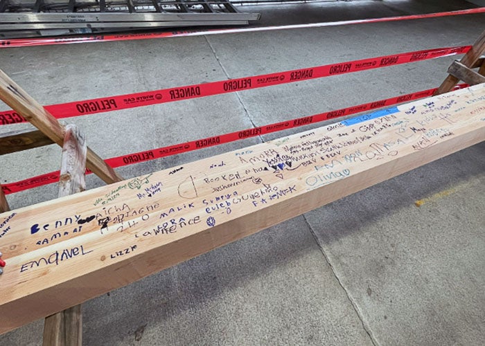 a wooden beam with handwriting on it