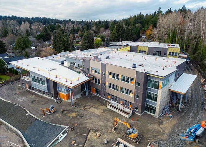 a view of a large building with two wings under construction