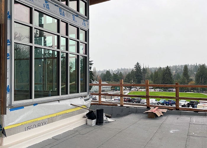 a patio under cover outside of large windows