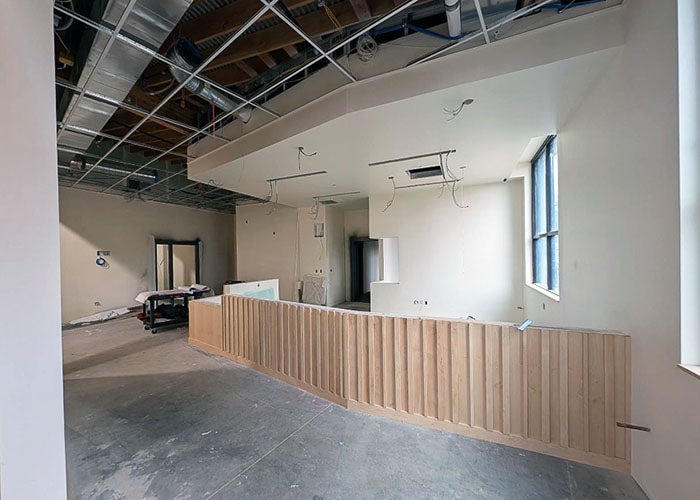 a room under construction with a curved slatted based for a desk