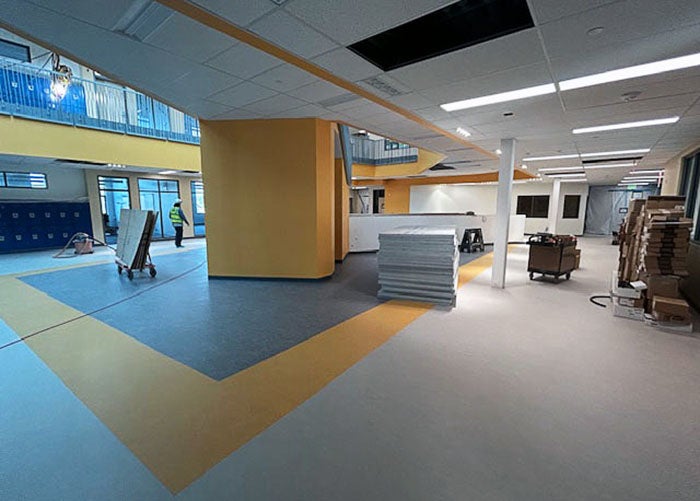 nearly complete central space with colored floor tiles forming square that is under the atrium
