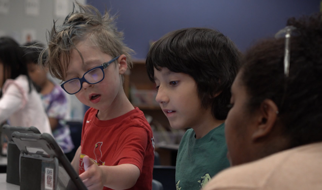 2 primary students on ipads