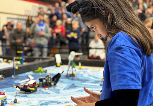 Student working at robotic table