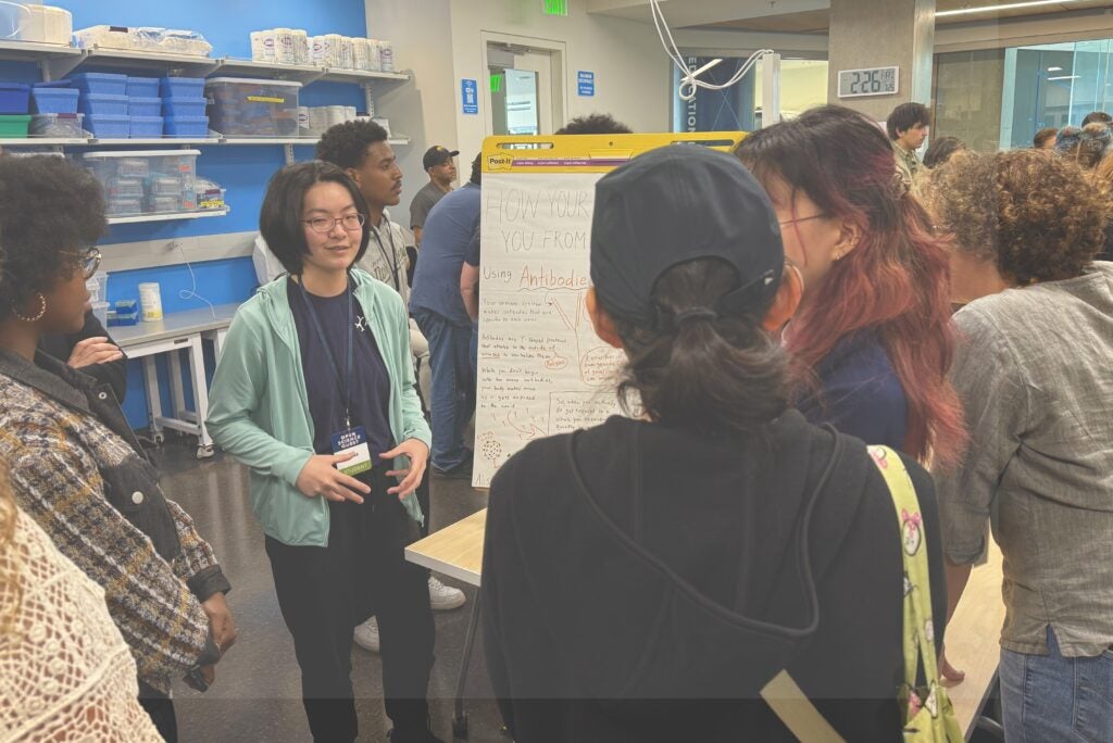 student presenting poster at science fair