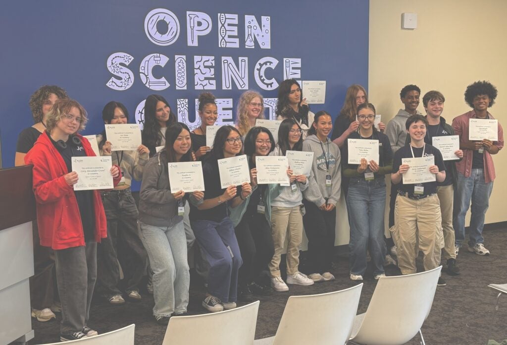 students posing with certificates of completion at open science quest