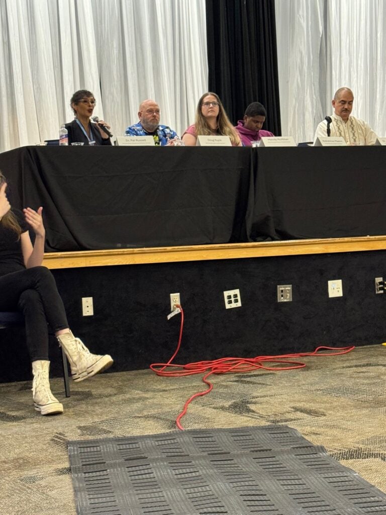 panelists sitting at a table with a black table cloth