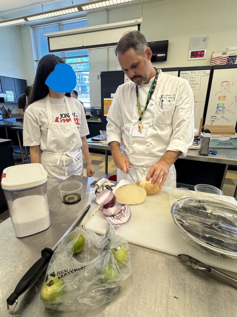 Teacher showing student a cutting technique