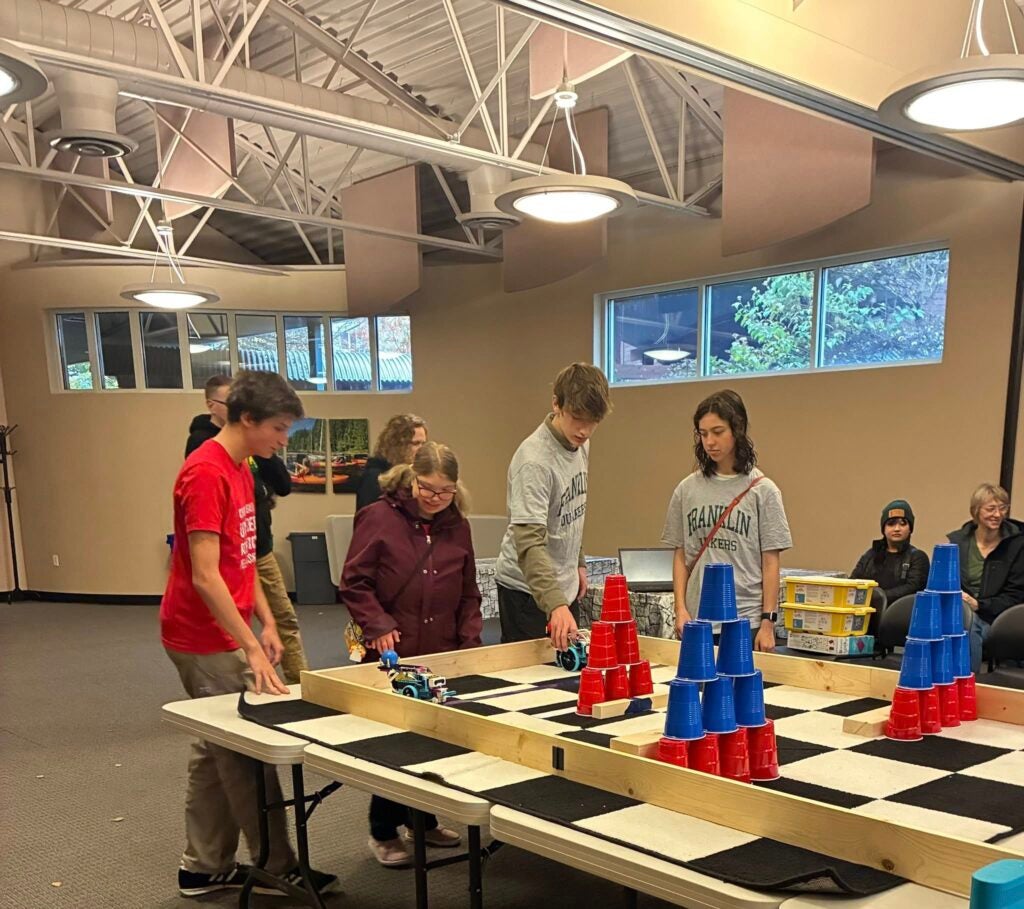 students setting up robots for competition