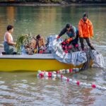 Students in the Ocean to Table Program on a boat, casting a net