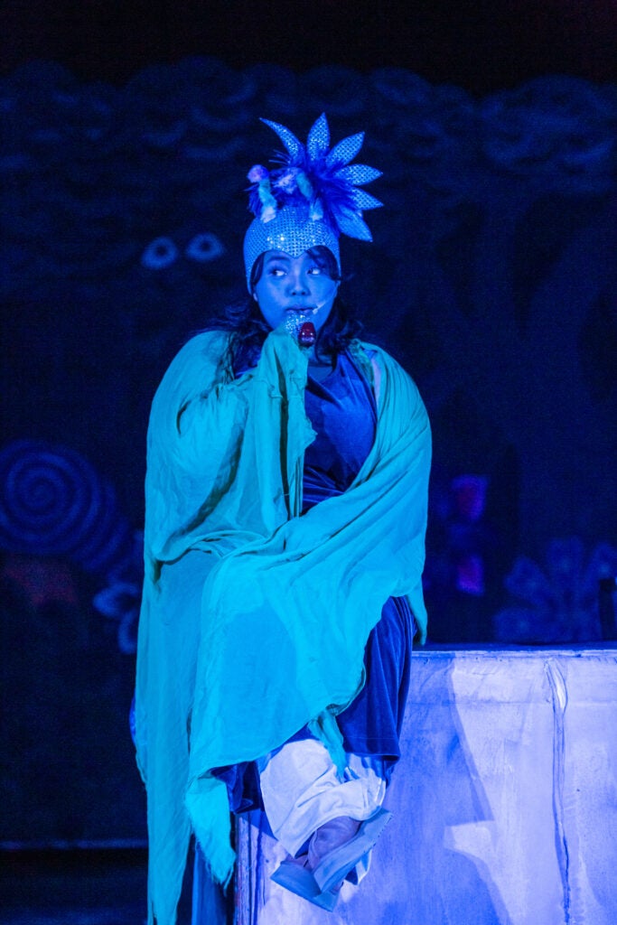 blue tinted picture of a student in a catepillar costume