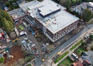 aerial view of a building under construction. Equipment and materials surround the project