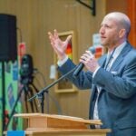 Superintendent Shuldiner speaking to the community during the community meeting at Salmon Bay