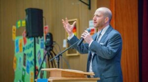 Superintendent Shuldiner speaking to the community during the community meeting at Salmon Bay
