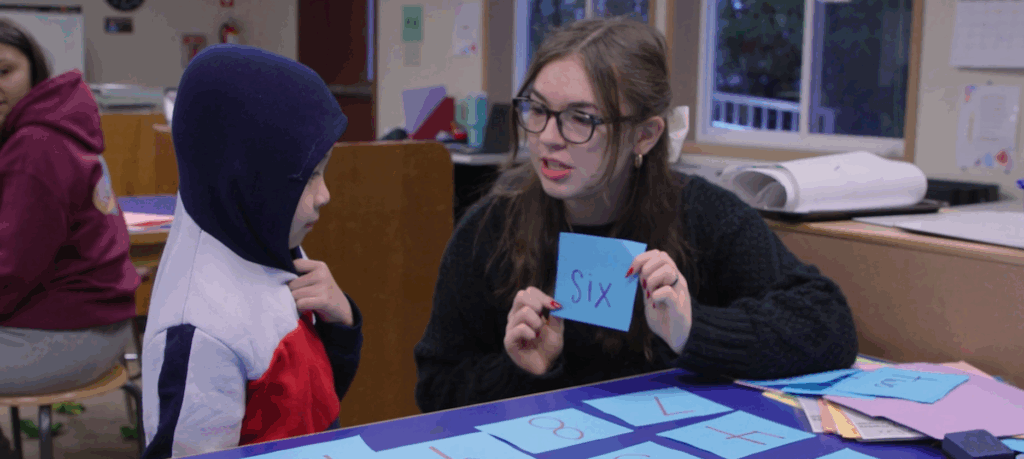 student mentoring a younger student 