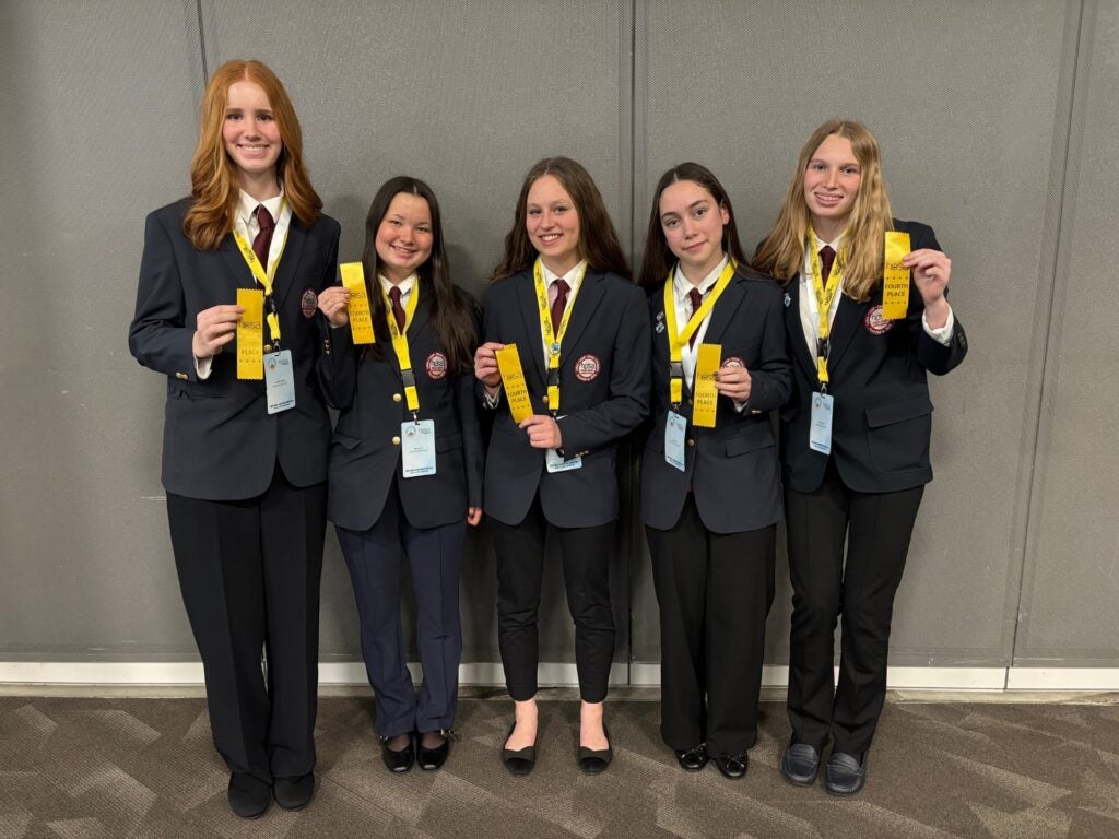 Students holding yellow ribbons marking accomplishments at HOSA