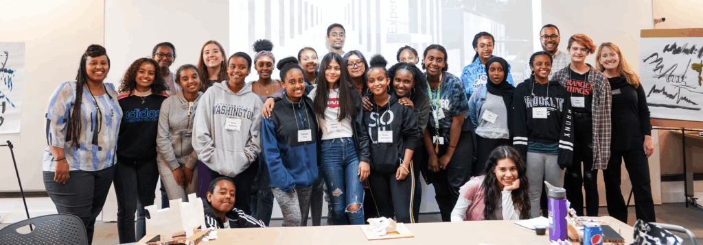 group of interns standing in front of architectural projection