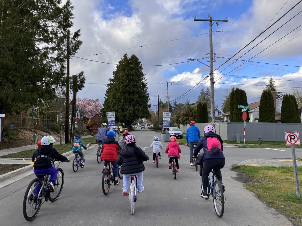 Group of people biking down a street.
