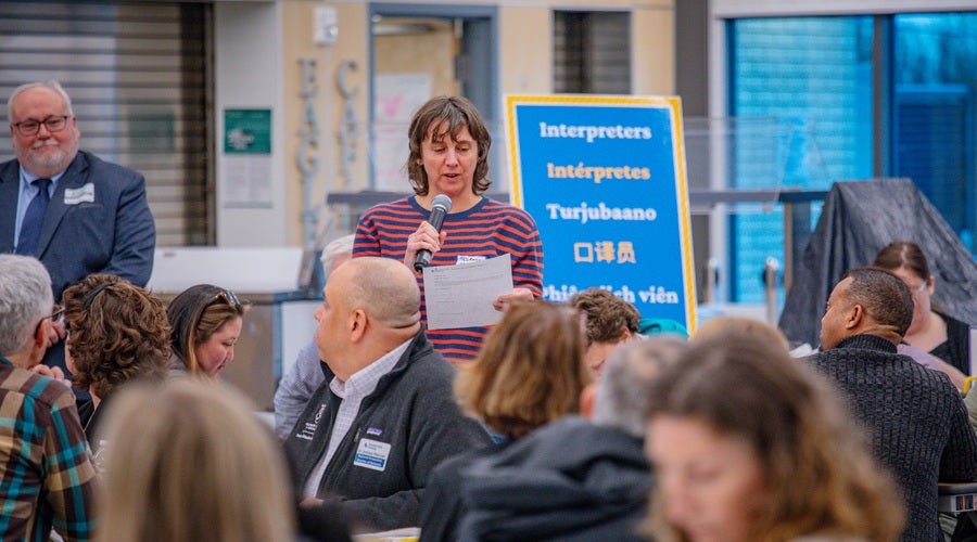 Community member speaking at James Baldwin Elementary School March 26, 2026 community meeting.