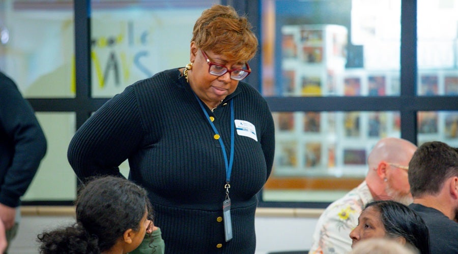SPS Chief of Staff and Public Affairs, Bev Redmond, speaking to community member at McClure Middle School March 24, 2026 community meeting.