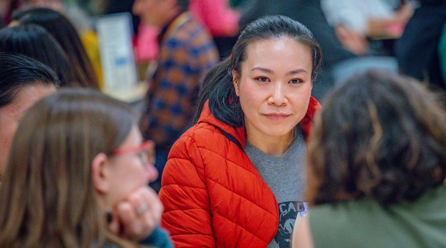 Community members sitting at tables in Salmon Bay K-8 school March 10, 2026 community meeting.