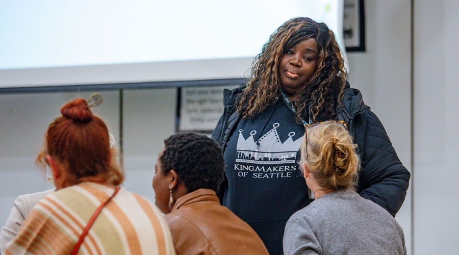 Community members talking to SPS staff at West Seattle Elementary School March 31, 2026 community meeting