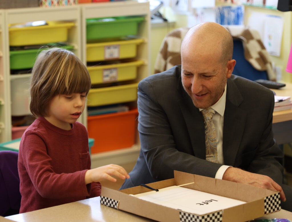 Seattle Public Schools Superintendent Ben Shuldiner watches as a student tests their makeshift pinball machine at Alki Elementary during his tour of the school in February. The superintendent is more than halfway through his goal of visiting all 106 schools in the district. He’s on track to finish touring schools in early May.