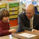 Seattle Public Schools Superintendent Ben Shuldiner watches as a student tests their makeshift pinball machine at Alki Elementary during his tour of the school in February. The superintendent is more than halfway through his goal of visiting all 106 schools in the district. He’s on track to finish touring schools in early May.
