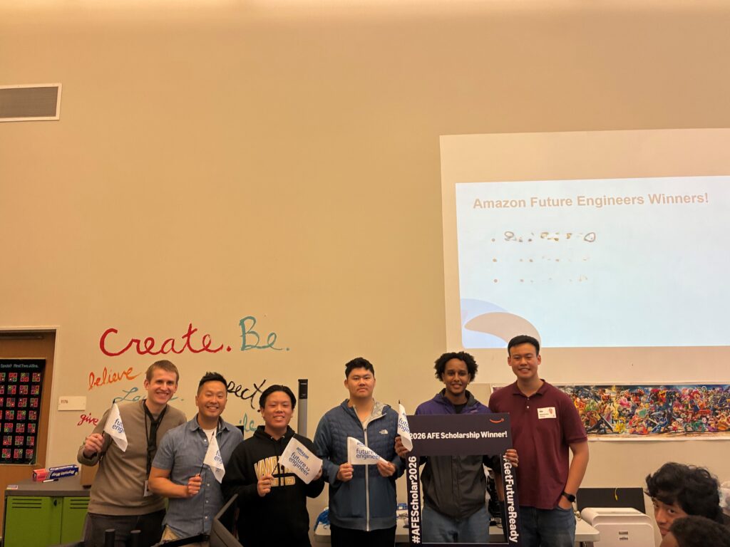 students posing in CS classroom after earning scholarship