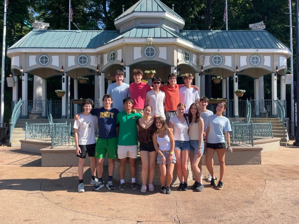 group of students posing in front of a gazebo-like structure