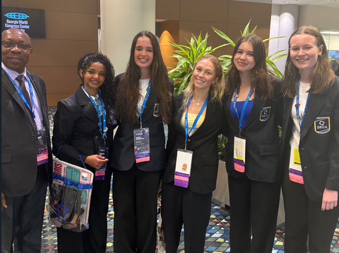 students wearing suits standing in a row