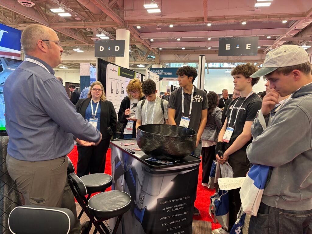 students standing in front of a booth 
