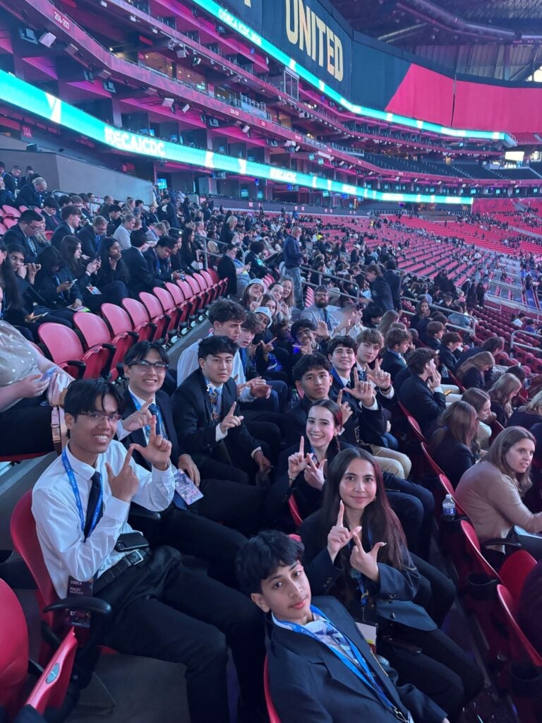 students in stadium seats smiling
