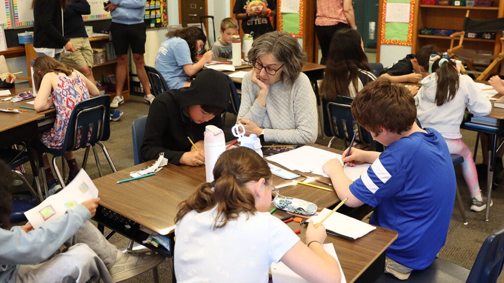 Teacher Crossman teachers math to students.