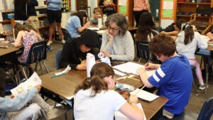 Teacher Crossman teachers math to students.