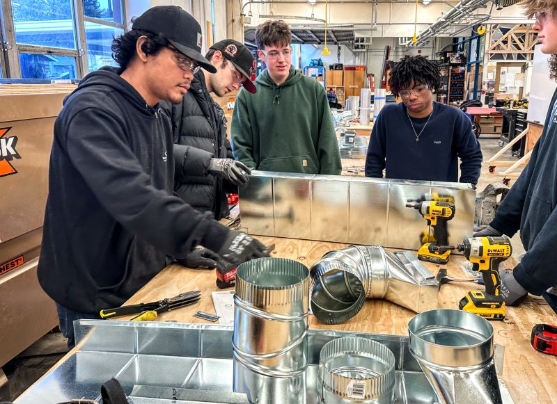 students doing measurements and sheetmetal construction for pre-apprenticeship program