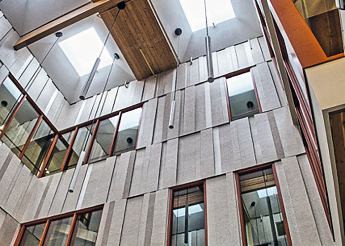 looking up a tall atrium toward sky lights
