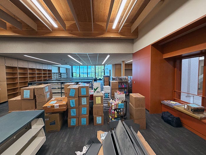 a large room with boxes stacked in front of shelving