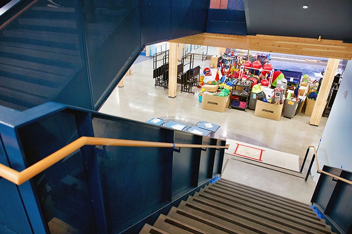 looking down a set of stairs toward an open space with stairs to the left that go up