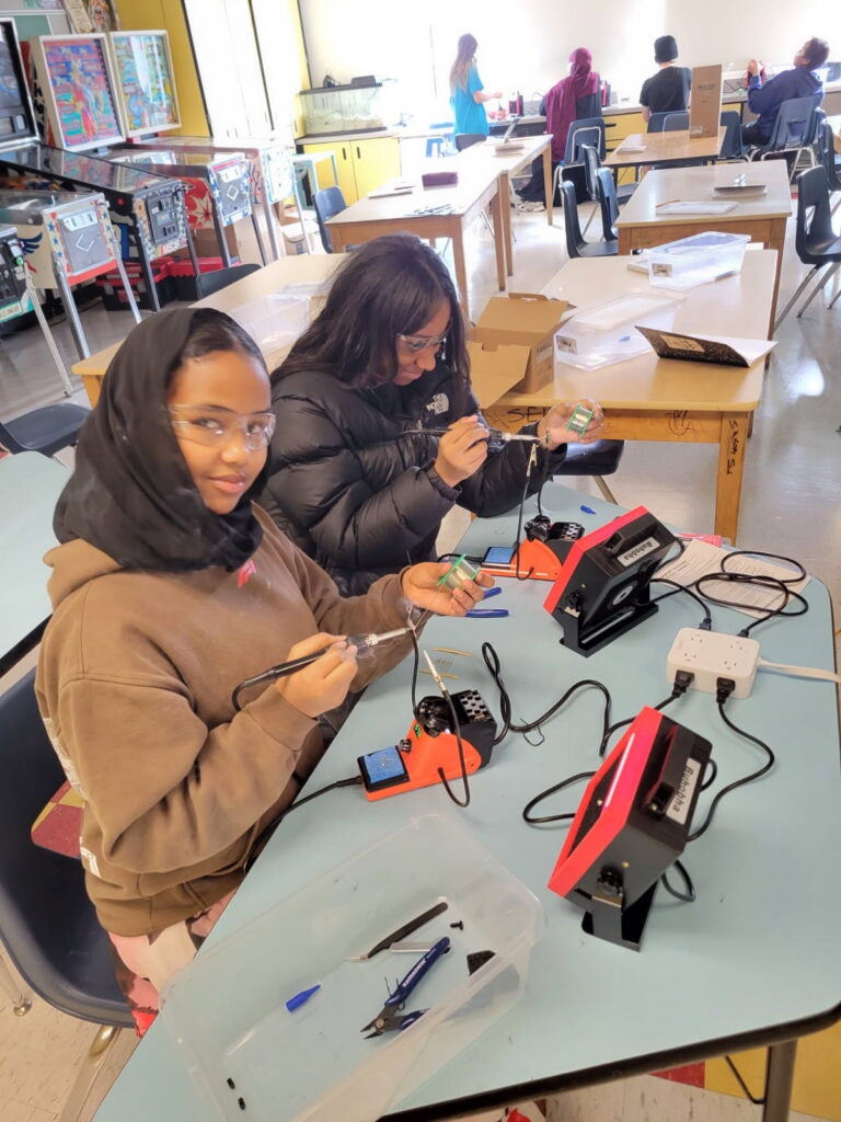 scholars have learned how to safely use a soldering iron, practiced soldering by creating figurines out of electronic components, and started making electronics using soldering kits.