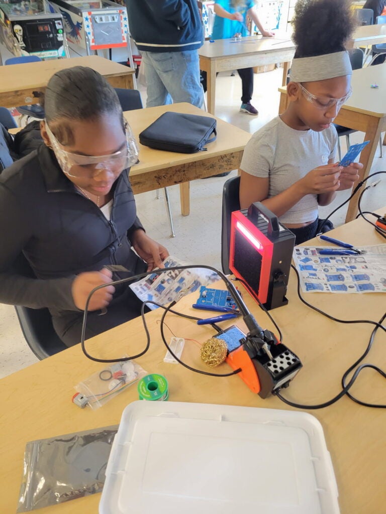 scholars have learned how to safely use a soldering iron, practiced soldering by creating figurines out of electronic components, and started making electronics using soldering kits.