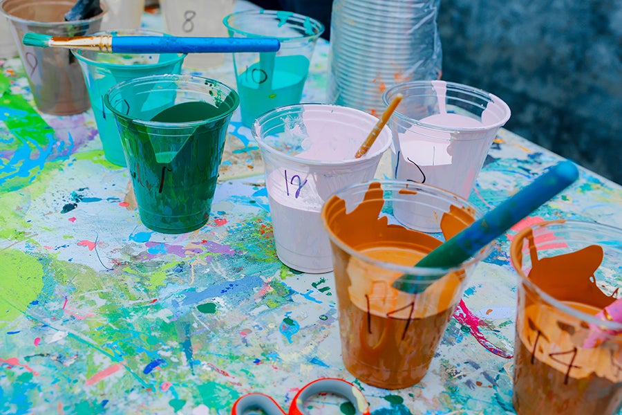 cups of paint with brushes