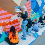 Students and Staff painting mural