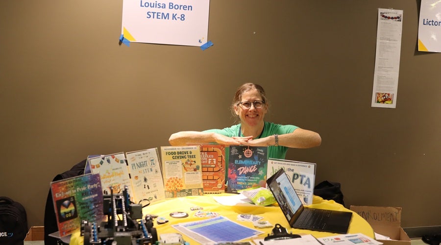Louisa Boren staff at a table at the January 2026 Enrollment Fair