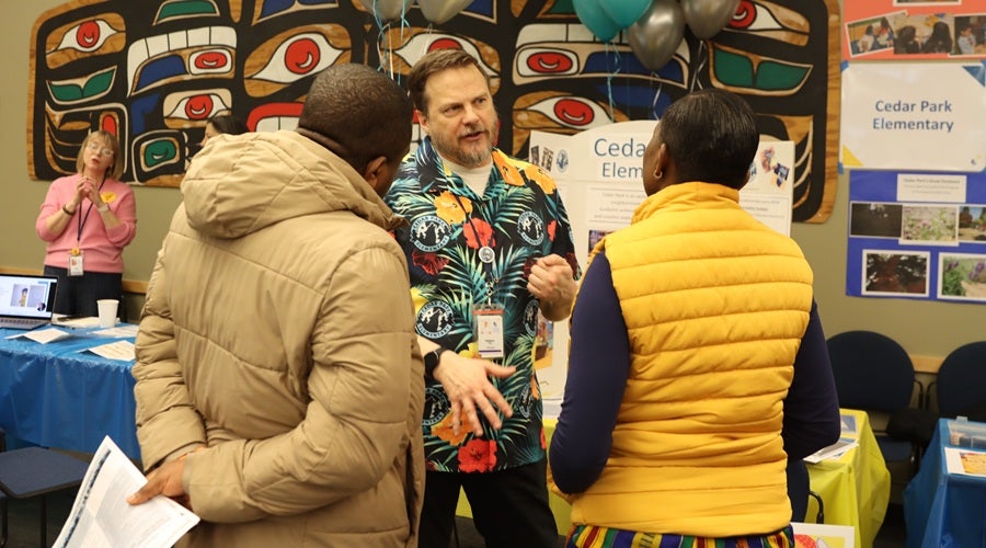Cedar Park Elementary staff talking to prospective students and families at the January 2026 Enrollment Fair