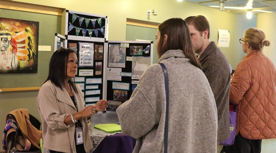 Hazel Wolf K-8 staff talking to prospective students and families at the January 2026 Enrollment Fair