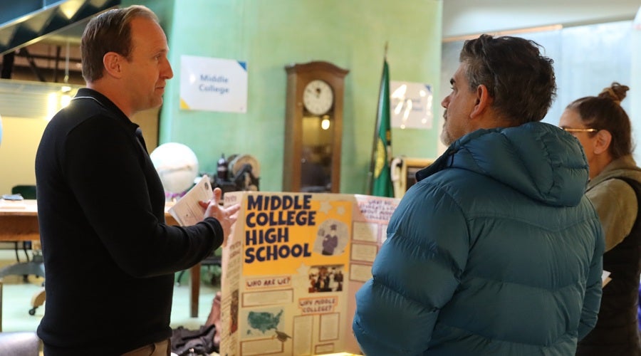 Middle College Principal Keven Wynkoop talking to a prospective family at the January 2026 Enrollment Fair