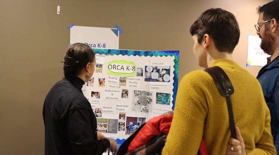 Orca staff talking to prospective students and families at the January 2026 Enrollment Fair