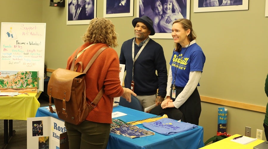 Roxhill staff talking to prospective students and families at the January 2026 Enrollment Fair