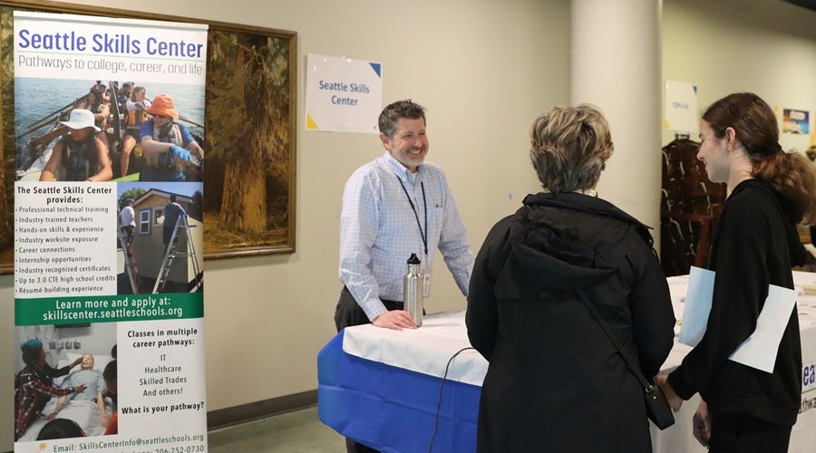 Seattle Skills Center Principal Dan Golosman talking to a prospective family at the January 2026 Enrollment Fair