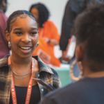 Student talking to a college rep at the Seattle Black College Expo